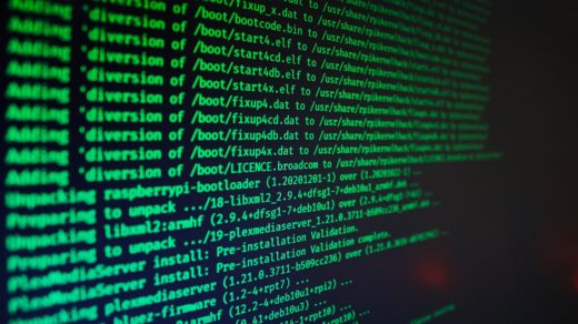 Green terminal code scrolling on a dark screen, evoking early Unix/Linux kernel development