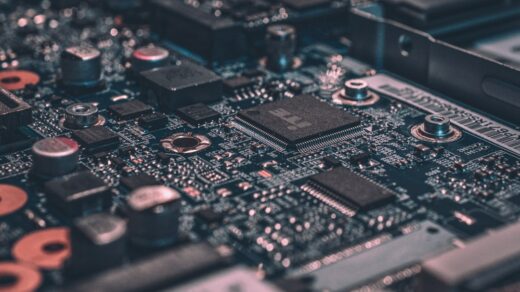 Macro photograph of a black semiconductor circuit board, representing Intel's chip technology