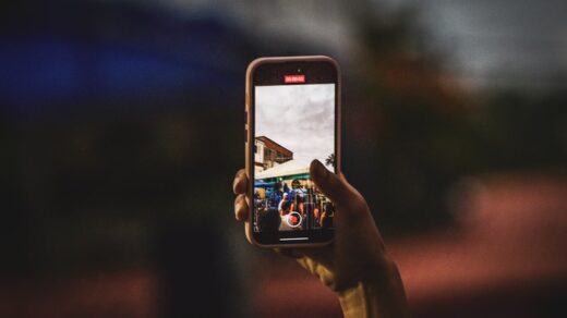 Person taking a photo with a smartphone, evoking mobile photo-sharing apps like Instagram